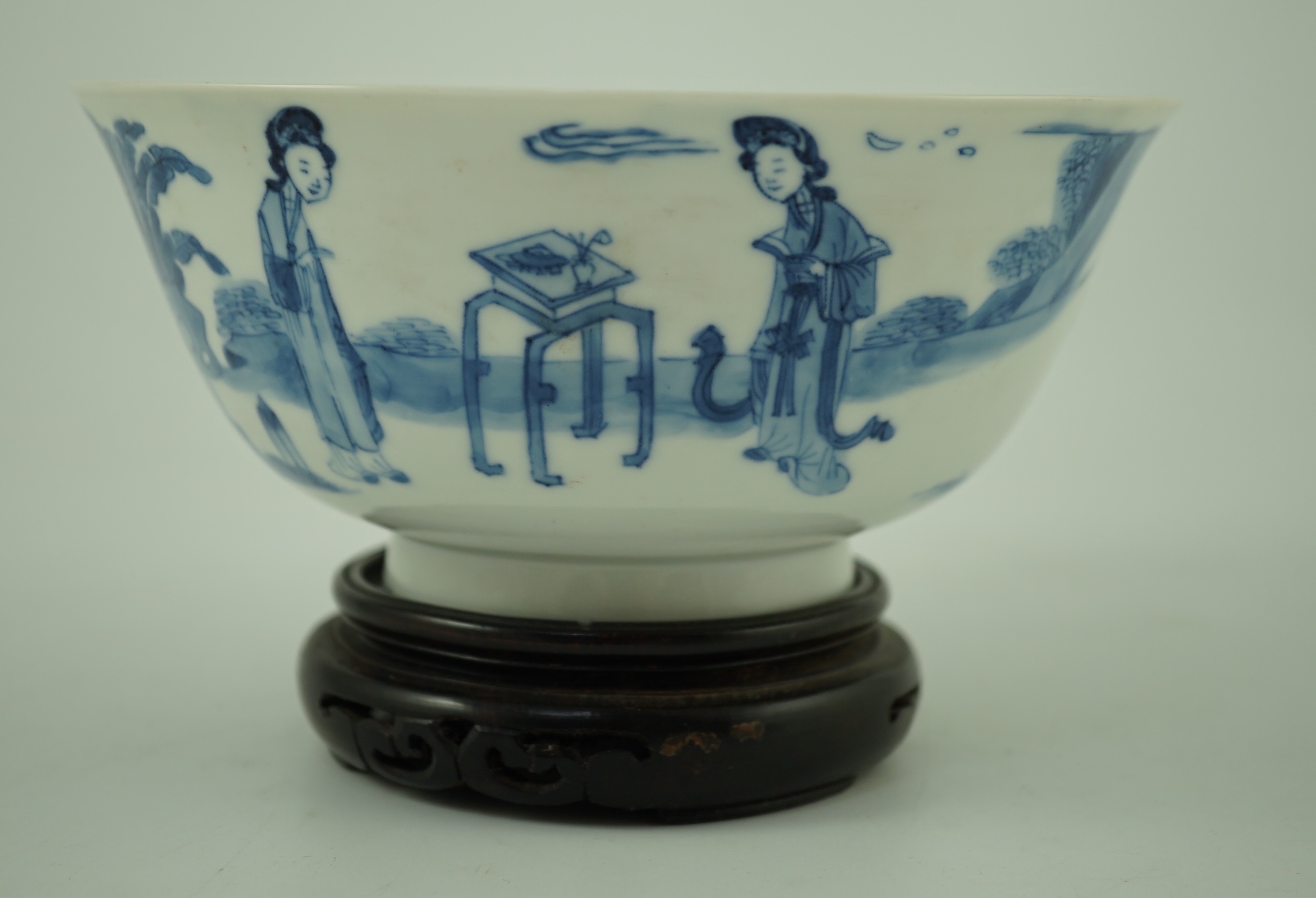 A Chinese blue and white ‘ladies’ bowl, Kangxi period, 15.5cm diameter, wood stand